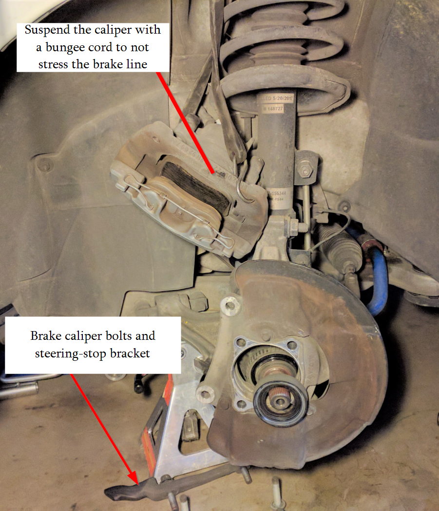 Suspend the caliper from the spring